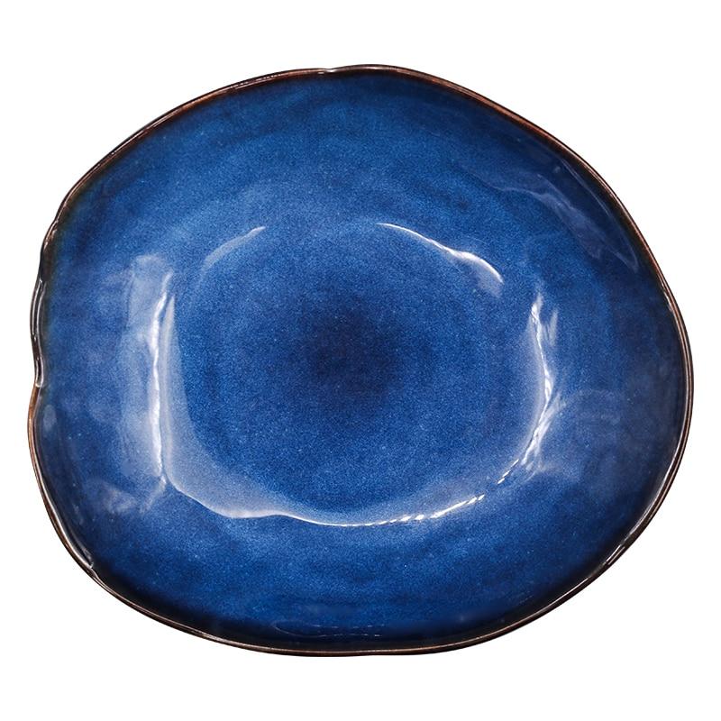 Atlas Dinner Plate, deep blue ceramic with an organic shape and dark brown rim.