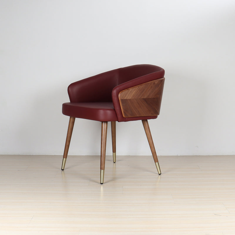 Modenal Dining Chair in maroon solid leather with wood paneling and gold-capped tapered legs.