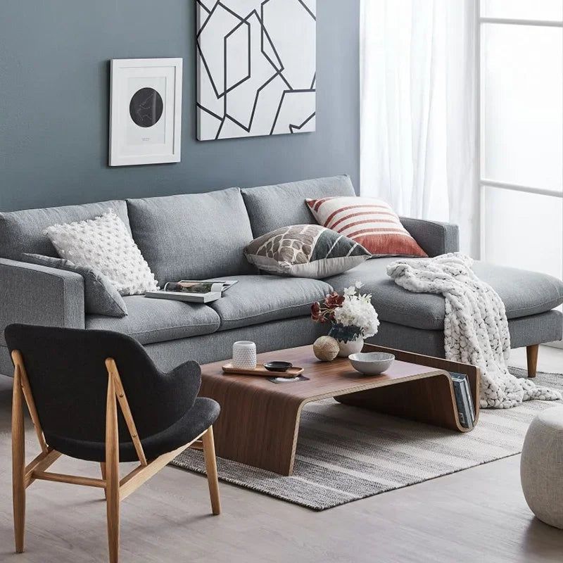 Montecito Coffee Table: Mid-century modern walnut wood coffee table with curved design in a living room.