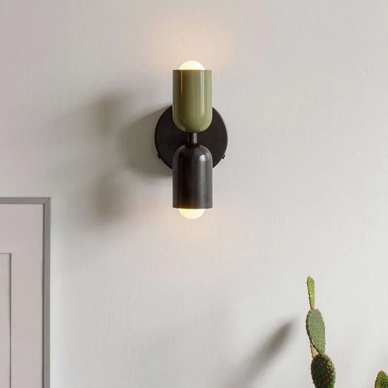Mura Wall Light, a modern two-tone olive green and black metal wall sconce with exposed bulbs.