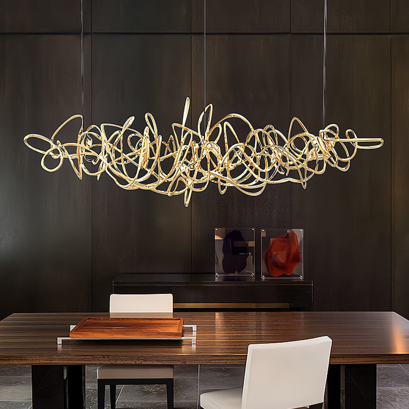 Parcaso Chandelier: Modern gold metal ribbon chandelier over a dark wood dining table.