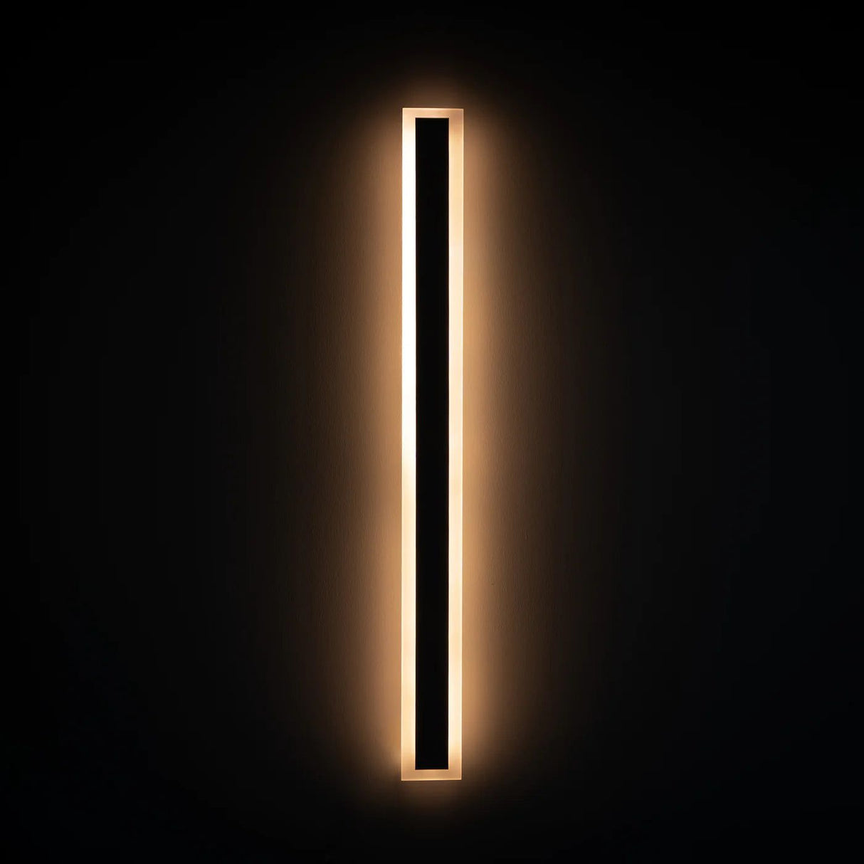 Spire Outdoor Wall Light, a long rectangular black fixture with a warm glowing LED strip.