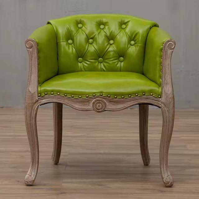 Willem Accent Chair in green apple leather with tufted back, nailhead trim, and carved light wood frame.