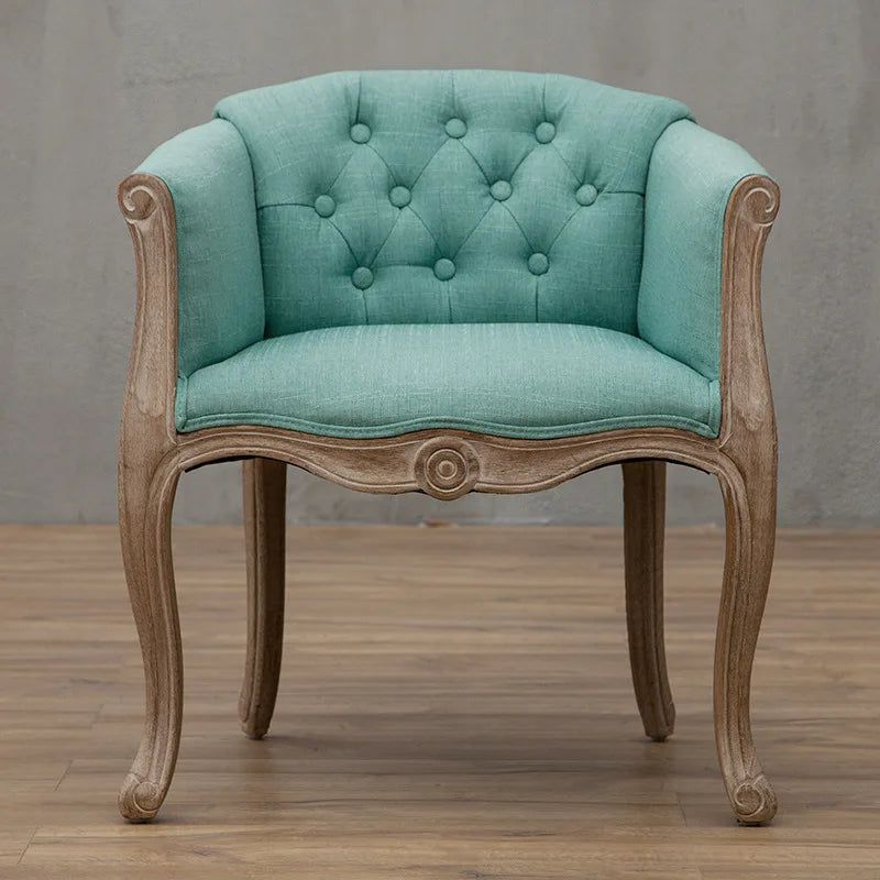 Willem Accent Chair in turquoise linen with tufted back and carved light wood frame.