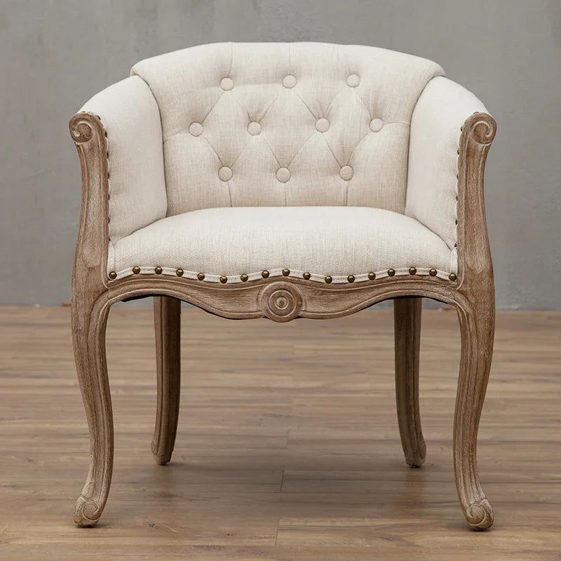 Willem Accent Chair in white linen with tufted back, nailhead trim, and carved natural wood frame.