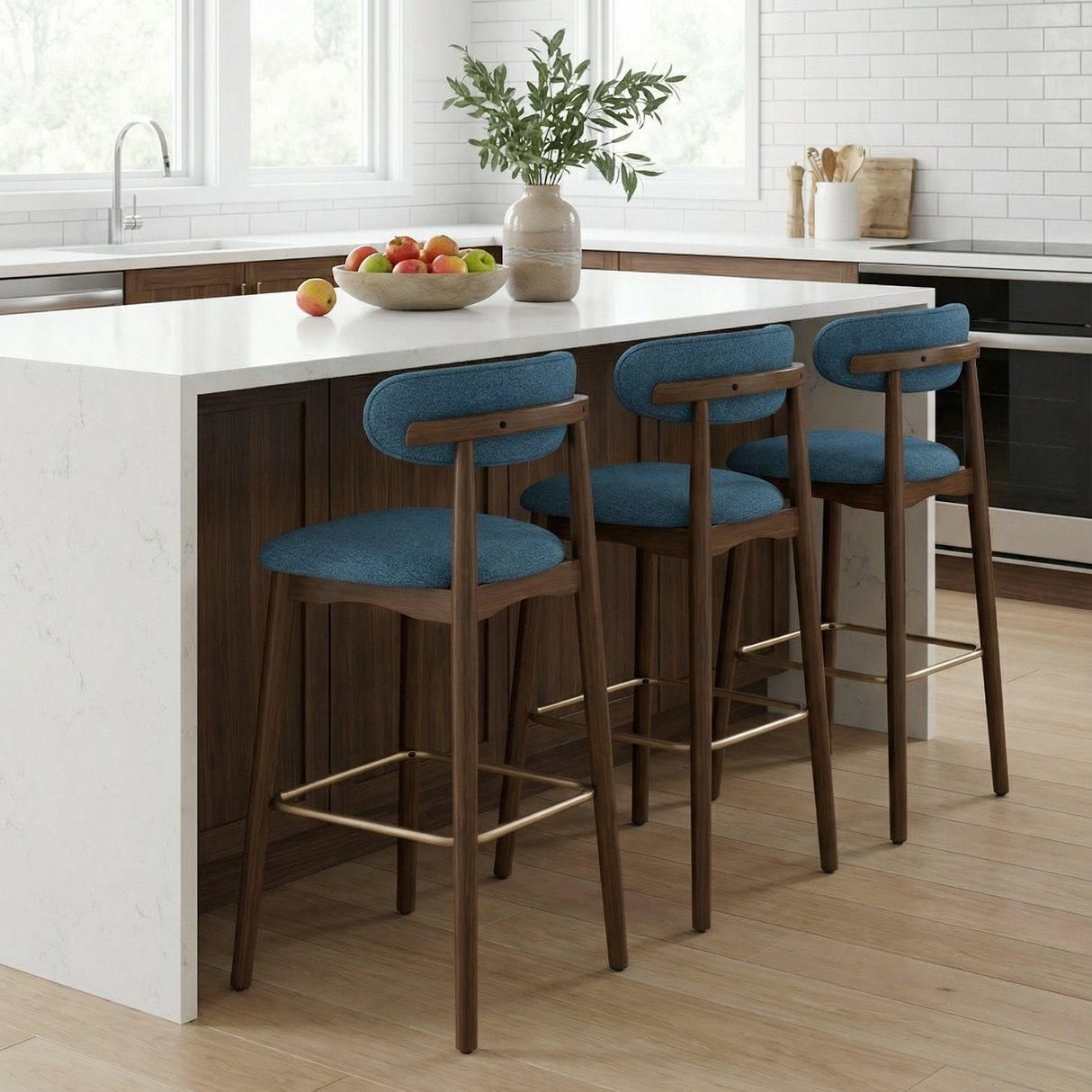 Norden Bar Stool. Three mid-century modern bar stools with teal fabric seats and walnut wood frames in a kitchen.