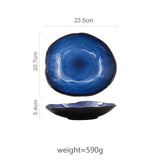 Large Atlas dinner plate, deep blue ceramic with irregular shape and dark rim, 23.5cm wide.