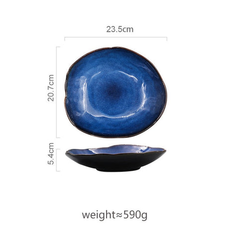 Large Atlas dinner plate, deep blue ceramic with irregular shape and dark rim, 23.5cm wide.