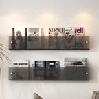 Avenue wall-mounted magazine shelf in smoke acrylic, holding magazines on a white wall.
