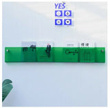 Green Avenue Wall-Mounted Magazine Shelf, 30cm, holding four magazines on a white wall.