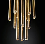 Evora pendant chandelier with multiple brass tubes and clear crystal accents.