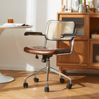 Lox Office Chair in dark brown leather with a natural cane back, chrome base, and casters.