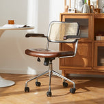 Lox Office Chair in dark brown leather with a natural cane back, chrome base, and casters.