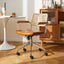 Lox office chair with light brown leather seat, cane back, wood arms, and chrome rolling base.