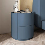 Mira Bedside Table in Haze Blue, a round nightstand with two drawers and a flat top surface.