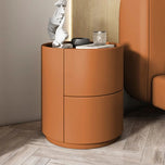 Orange Mira Bedside Table, a round nightstand with two drawers and a flat top surface.