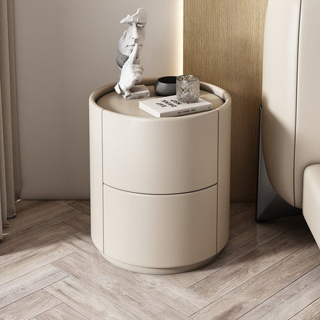 Mira Bedside Table: Round beige leather nightstand with two drawers and a recessed top.