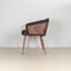 Modenal dining chair in coffee solid wood with chevron back and brass-capped legs.