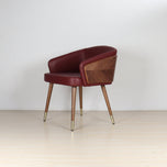 Modenal Dining Chair in maroon solid leather with wood paneling and gold-capped tapered legs.