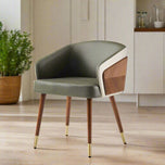 Modenal Dining Chair in green leather with beige trim, walnut wood accents, and gold-capped tapered legs.