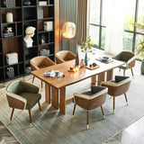 Modenal dining chair in green and brown leather with wood and gold legs, around a wooden dining table.