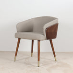 Modenal Dining Chair: Beige solid upholstered chair with walnut wood accents and brass-capped legs.
