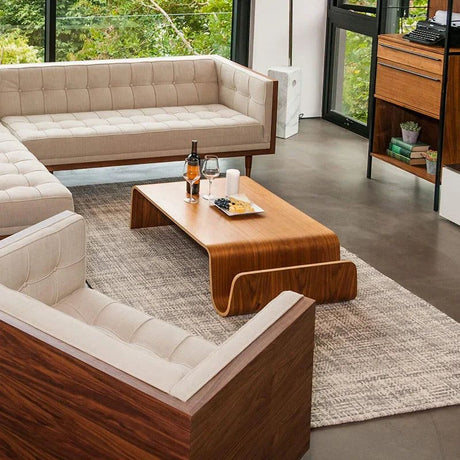 Montecito Coffee Table: Mid-century modern curved walnut wood coffee table in a living room.