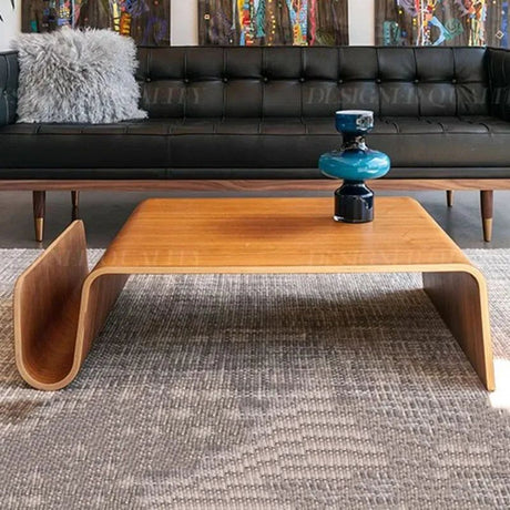 Montecito Coffee Table: Mid-century modern bentwood coffee table with a light brown finish and curved magazine holder.
