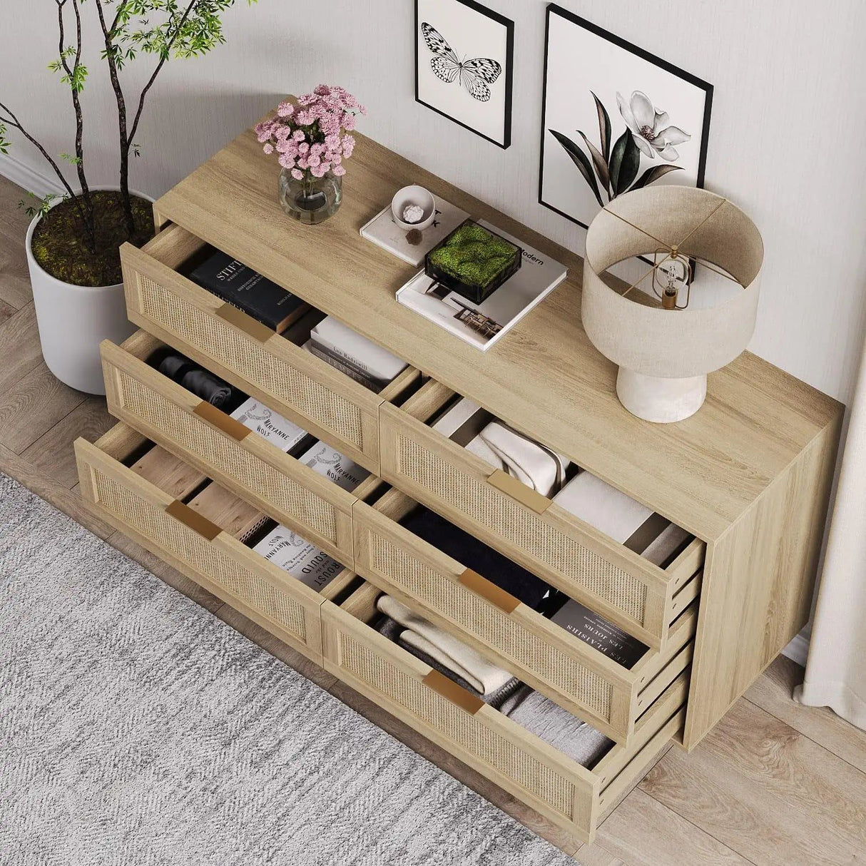Morello dresser with light wood finish and six cane-front drawers, some open revealing folded clothes.