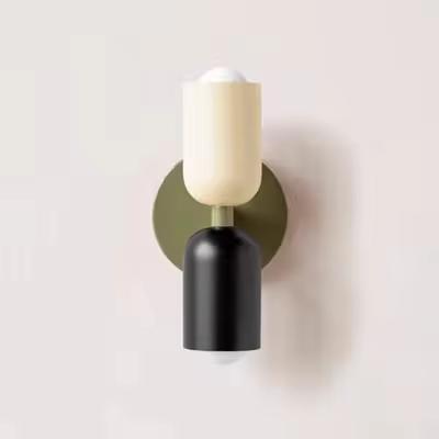 Mura Wall Light, a modern wall sconce with cream and black cylindrical shades on an olive green base.
