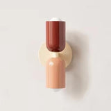 Mura Wall Light, Style 2: Modern wall sconce with stacked terracotta and peach cylindrical shades.