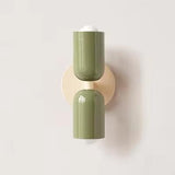 Mura Wall Light, Style 4. Two olive green cylindrical shades on a round beige backplate.