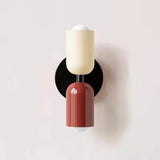 Mura Wall Light, a modern wall sconce with cream and terracotta cylindrical shades on a black circular base.