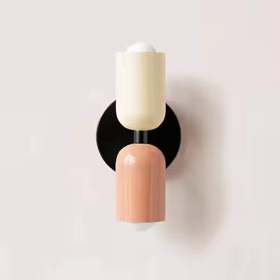Mura Wall Light, Style 8, with two ceramic shades: one cream, one peach, on a black metal base.