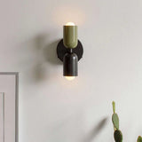 Mura Wall Light, a modern two-tone olive green and black metal wall sconce with exposed bulbs.