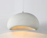 Nara pendant light, 12 inch white textured stone-like dome with warm glow.