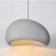 Nara pendant light, 12-inch light gray, with a textured, organic-shaped shade and warm glow.