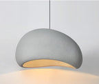 Nara pendant light, 12-inch light gray, with a textured, organic-shaped shade and warm glow.
