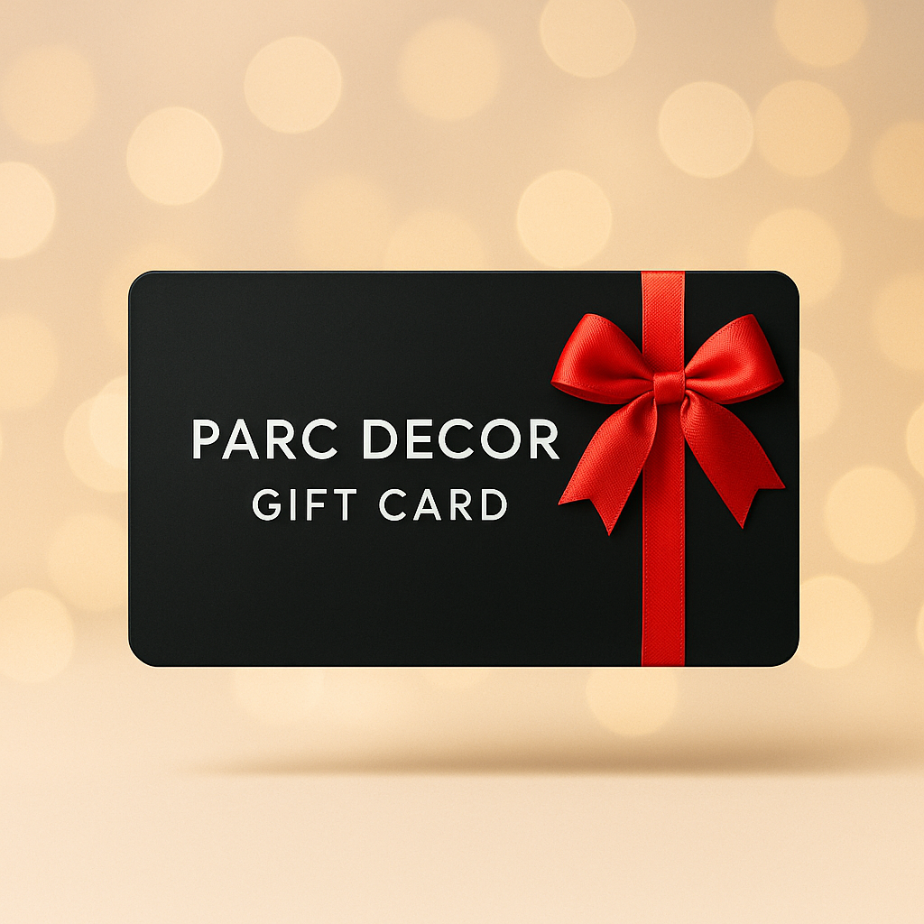Black gift card with "PARC DECOR GIFT CARD" text and a red ribbon bow on a bokeh background.
