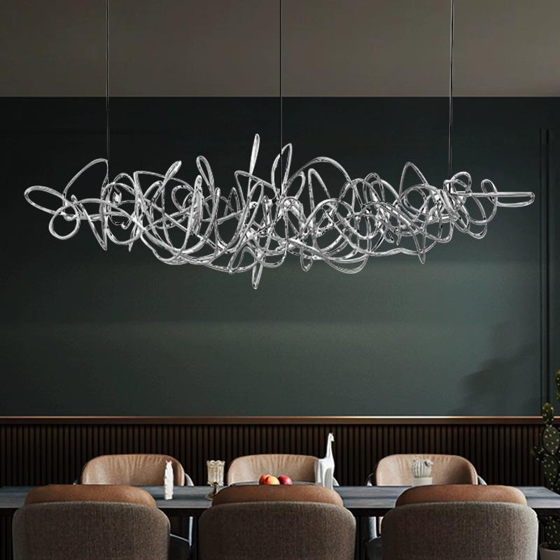Parcaso Chandelier, 80cm chrome abstract linear chandelier with warm white light over a dining table.