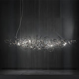 Parcaso Chandelier: Modern chrome chandelier with intertwined metal ribbons and multiple lights.
