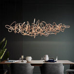 Parcaso Chandelier, 80cm rose gold abstract linear chandelier with warm white light over a dining table.