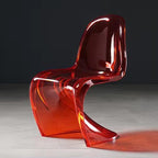 Sora Dining Chair in translucent red acrylic with a wavy, modern S-shape design.