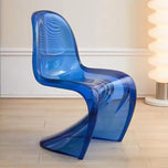 Sora dining chair in translucent blue acrylic with a curved, modern design on a wood floor.