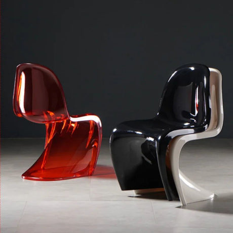 Sora Dining Chairs: one translucent red, one black and white, both with curved, modern plastic designs.