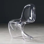 Sora Dining Chair, clear acrylic with a curved, wavy design.