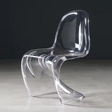 Sora Dining Chair, clear acrylic with a curved, wavy design.