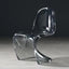 Sora Dining Chair in gray tint. Modern, clear acrylic dining chair with a curved, flowing design.