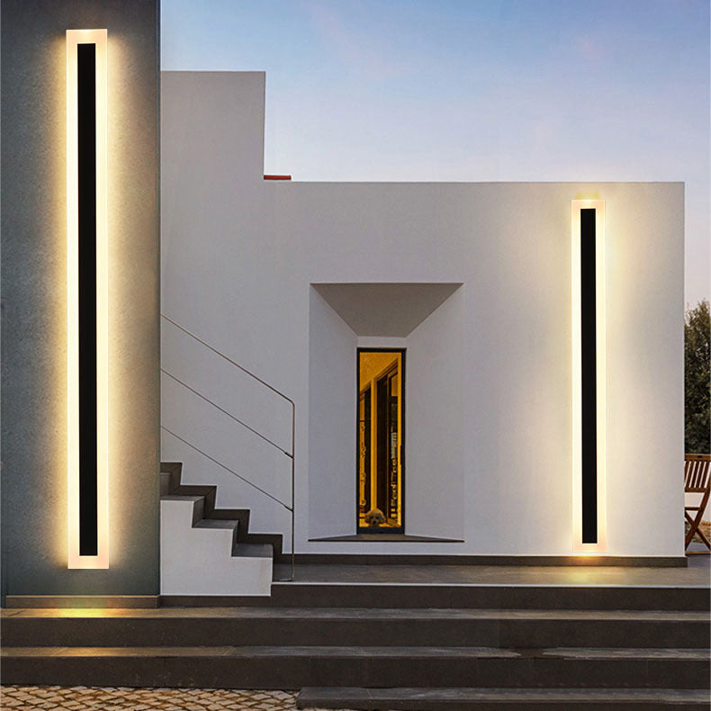Spire Outdoor Wall Light, a tall black rectangular modern outdoor wall sconce with warm white light.