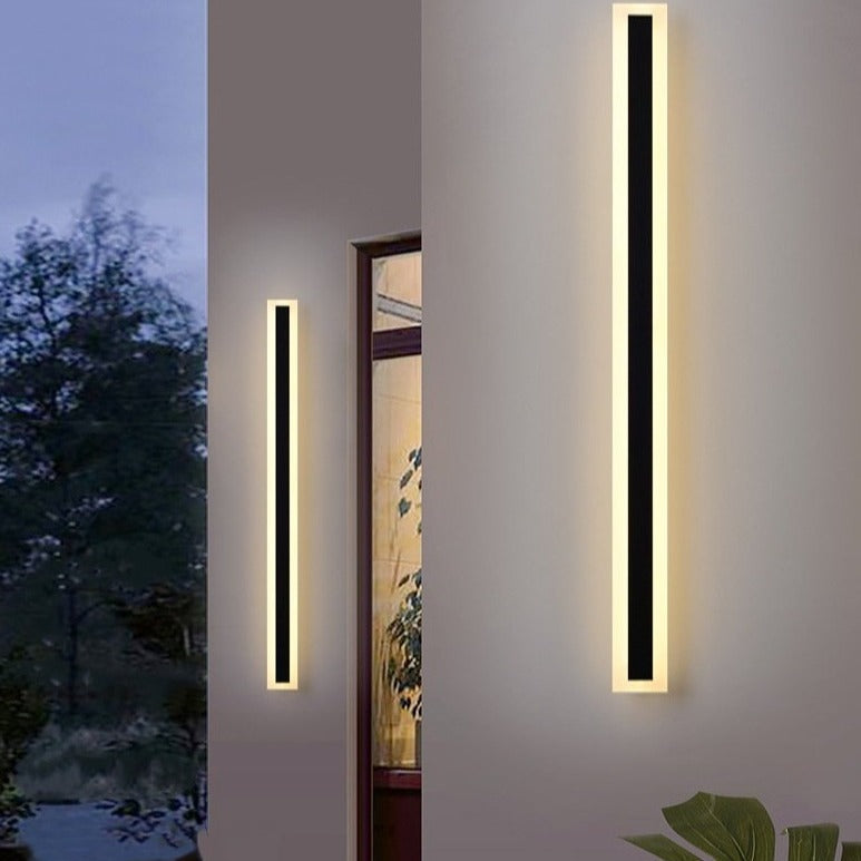 Spire Outdoor Wall Light, 30cm black dimmable LED wall sconce, modern linear design on a white wall.